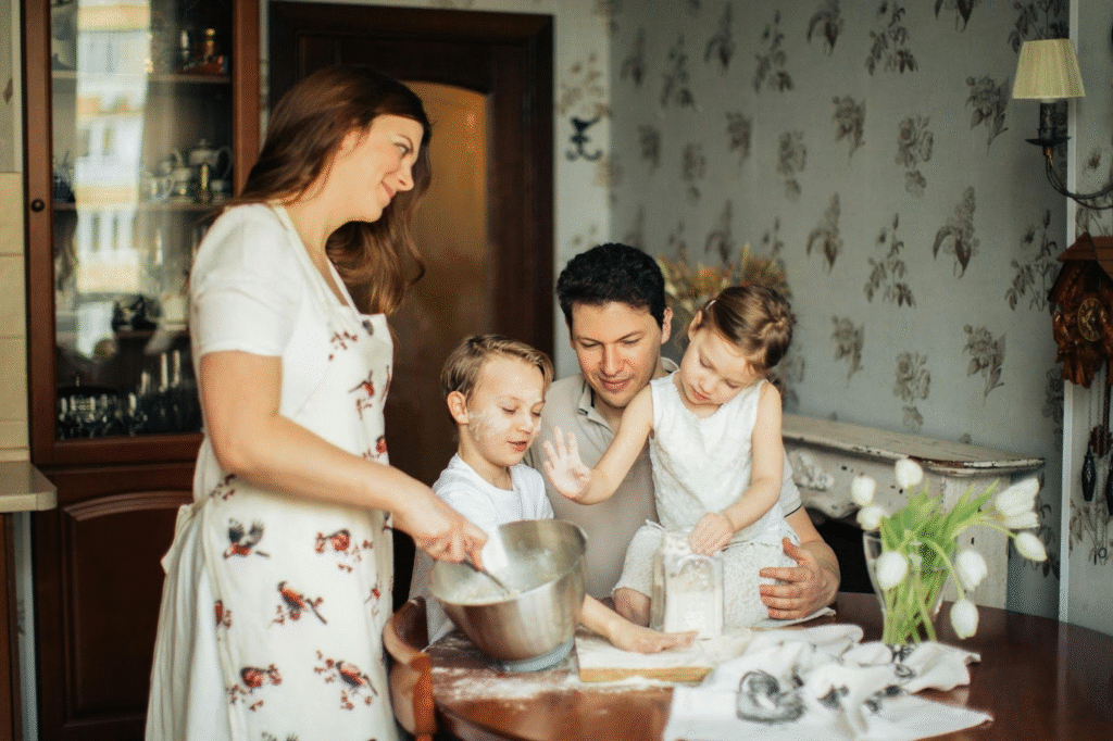 Happy family cooking together at home, representing improved energy, health and quality of life after weight loss surgery.